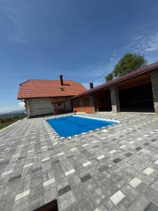 a patio with a swimming pool in front of a house at Садиба Сикитура in Verkhneye Vodyanoye