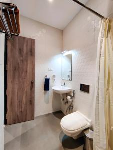 a bathroom with a toilet and a sink at Stay by Insata Hospitality - Kolkata in Kolkata