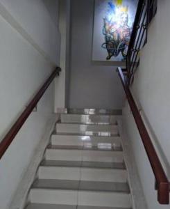 a stairway with a painting on the wall at Alfathpark in Nyomolong