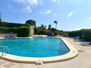 a swimming pool with blue water in a resort at Dulce Amor in Casas Abiar