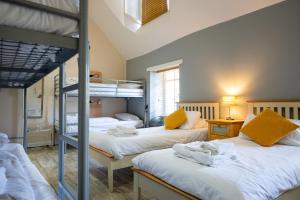 a bedroom with three bunk beds in a room at Callander Hostel in Callander +79 photos