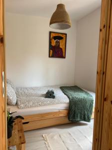 a bedroom with a bed and a painting on the wall at Strefa medytacji in Wólka
