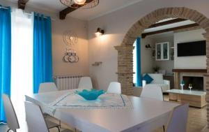 a dining room with a white table and chairs at Tre Laghi Countryhouse Luminous with pool and aircon in Citta' Sant'Angelo