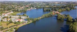 an aerial view of a large river with a town at Le clocher d Ardres in Ardres +9 photos