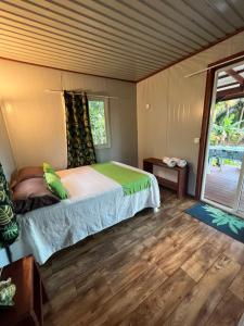 a bedroom with a bed and a large window at Kai Kabana Chill in HUH
