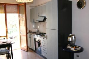 a kitchen with a refrigerator and a stove at Residenza Novalba in Riccione