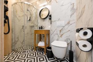 a bathroom with a toilet and a shower at GreenRoom Kunigiškės in Palanga +13 photos