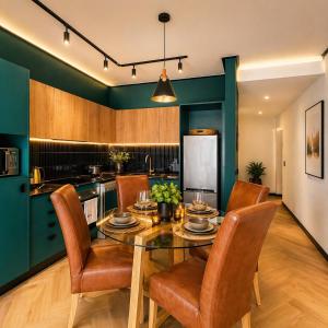 a dining room with a table and chairs in a kitchen at ZALS- Nine Palms -Luxury Two Bed in Cape Town