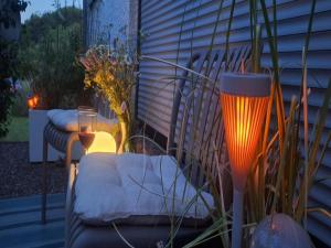 a patio with a couch and two glasses of wine at Waldzauber Retreat in Nohfelden