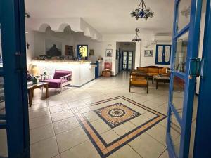 a living room with a couch and a table at Irigeneia Hotel in Perissa