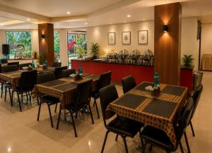 a restaurant with tables and chairs and a bar at Strand Resort in Lonavala