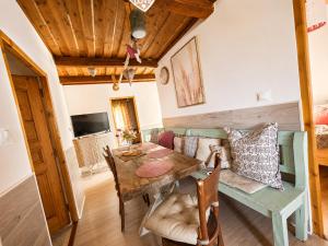 a dining room with a table and a couch at Penzión U Koníka in Liptovský Ján