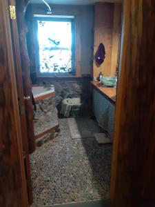 a bathroom with a sink and a window in it at Hungry Moose B and B in Kasilof