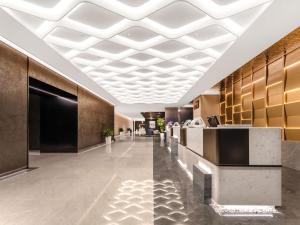 a lobby of a hotel with a white ceiling at Novotel Atlantis Shanghai in Shanghai +148 photos