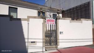 a door with a sign on the side of a building at Casa Bisavós de Coelhosa in Vale de Cambra
