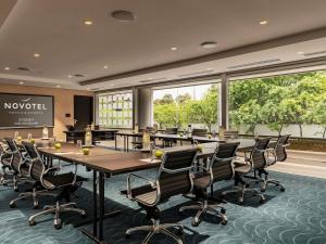 a conference room with a long table and chairs at Novotel Sydney Darling Square in Sydney +186 photos