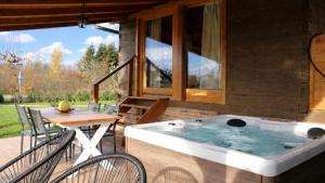 a hot tub on a patio with a table and chairs at Villa Velika by Villas Guide in Pisarovina