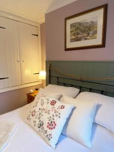 a bedroom with a bed with two pillows on it at Welsh Yard Retreat in Penrith