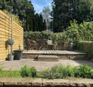 a patio with a bench and a table and chairs at Welsh Yard Retreat in Penrith