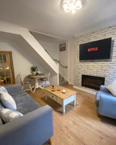 a living room with a couch and a fireplace at Welsh Yard Retreat in Penrith