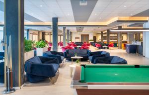 a lobby with couches and a pool table at Hunguest Szeged - ex Forrás in Szeged