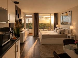 a hotel room with a bed and a large window at Timmendomizil - schöne Ferienwohnung in bester Lage - Sonnenseite in Timmendorfer Strand