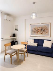 a living room with a blue couch and a table at Il Giramondo Suite&Room in Matera