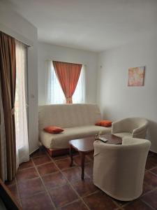 a living room with a couch and a table at Villa Ipera in Budva