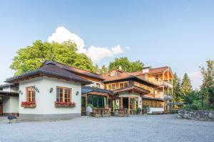 a large house with a patio in front of it at Nattererboden in Innsbruck