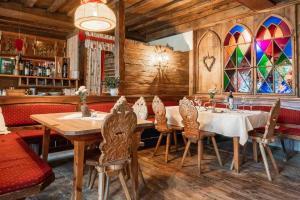 a dining room with a table and chairs and stained glass windows at Nattererboden in Innsbruck