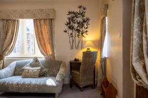 a living room with a couch and a table at Mount Pleasant Hotel Self-Catering Cottages in Doncaster