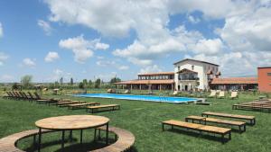 a resort with a pool with benches and a building at Mtevino in Khashmi