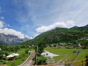 a green field with a mountain in the background at Stilios guesthouse in Grumas