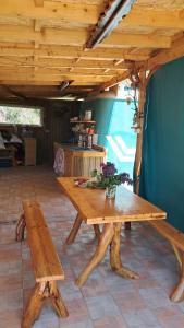 a wooden table and bench in a room at GeghardCamping in Goghtʼ