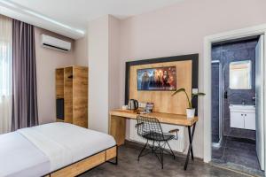 a hotel room with a bed and a desk at Dedem Hotel Express-İstanbul Airport-Round Trip Airport Service in Arnavutköy +41 photos