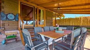 a wooden table and chairs on a patio at Villa Velika by Villas Guide in Pisarovina