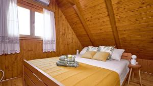 a bedroom with a bed in a wooden cabin at Villa Velika by Villas Guide in Pisarovina