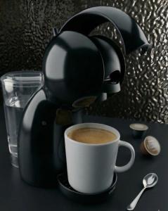 a coffee maker sitting next to a cup of coffee at Sotto Il Sole in Surčin +21 photos