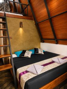 a bunk bed in a room with a ladder at Pahana village Sigiriya in Sigiriya