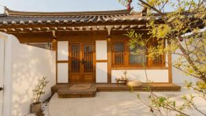 a house with wooden doors and a porch at 한옥스테이 설화 in Gyeongju +16 photos