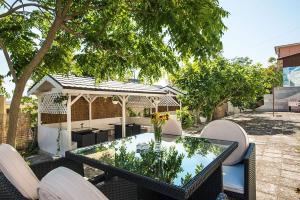 a patio with a table and chairs and a gazebo at Effect Saint Mina - SELF CHECK-IN in Sozopol