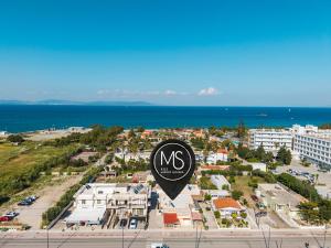 a sign in front of a city with the ocean at MSBeach Luxury Homes - Manolis in Kos