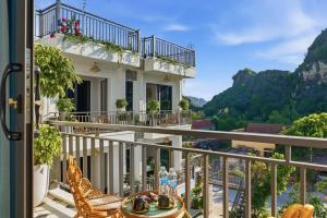 a balcony with a view of the mountains at Tam Coc Valley Hideaway in Vũ Lâm