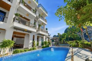 a hotel with a swimming pool in front of a building at Tam Coc Valley Hideaway in Vũ Lâm