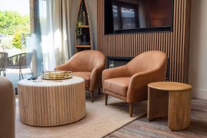 a living room with two chairs and a table at Retreat 1 in Beccles