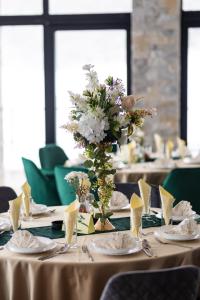 a table with a vase of flowers on it at Meandri in Nova Varoš