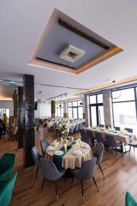 a restaurant with tables and chairs and a large mirror at Meandri in Nova Varoš