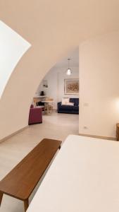 a bedroom with a bed and a living room at Il Giramondo Suite&Room in Matera