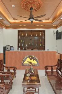 a restaurant with a table and chairs and a bar at Tam Coc Valley Hideaway in Vũ Lâm