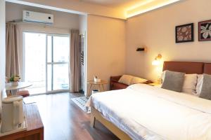 a bedroom with a large bed and a living room at Tulips apartment in Chengdu